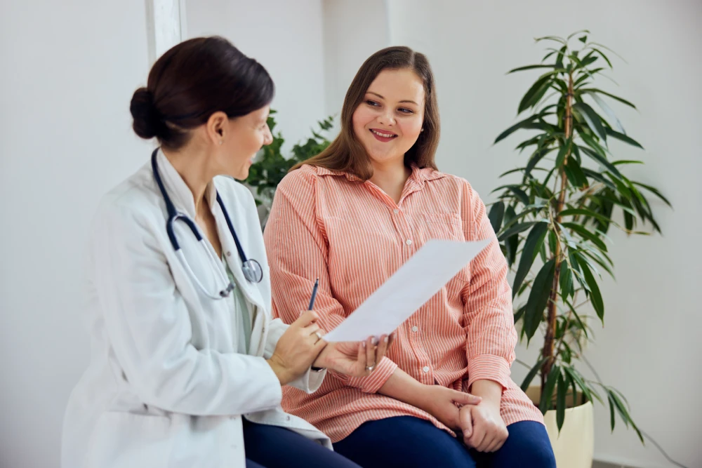 Doctor and patient discussing lipo laser options.