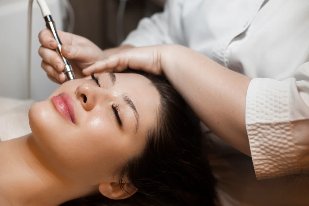 Professional performing a skincare procedure at a medical spa.